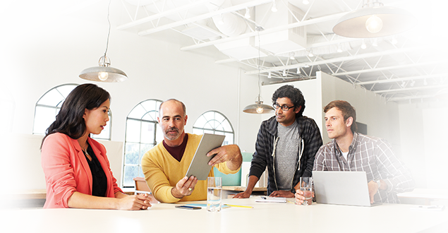 Image_CompanyResource_635x330-1 business people sitting and talking while looking at a tablet